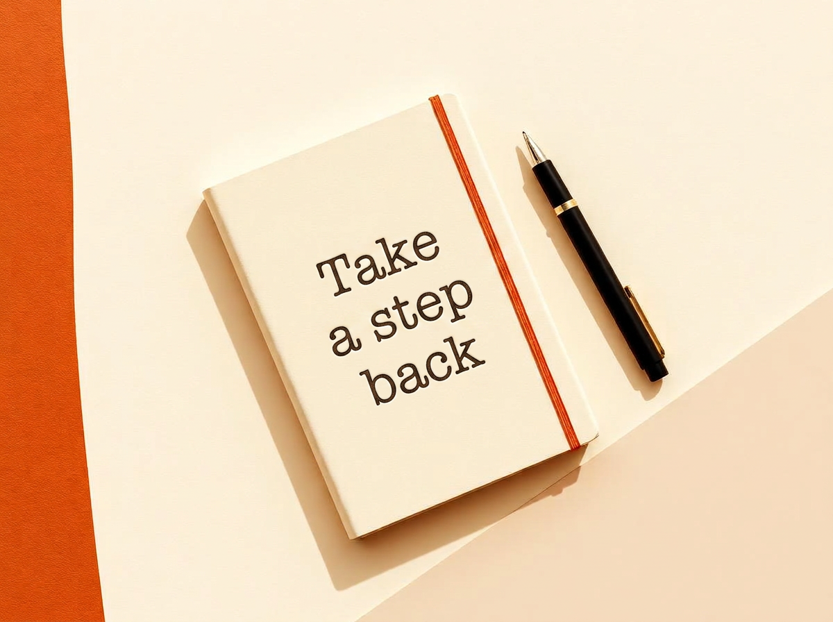 A daily memory journal with capture cards and a pen on warm paper